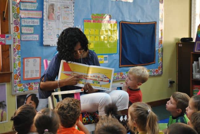 OFTC Early Childhood Care and Education student, Debra Dixon, reads to children at Lolly's Pre-Kindergarten & Learning Center where she works, thanks to certification she received from Oconee Fall Line Technical College.