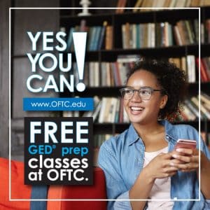 Woman holding phone smiling, Yes You Can! FREE GED prep classes at OFTC