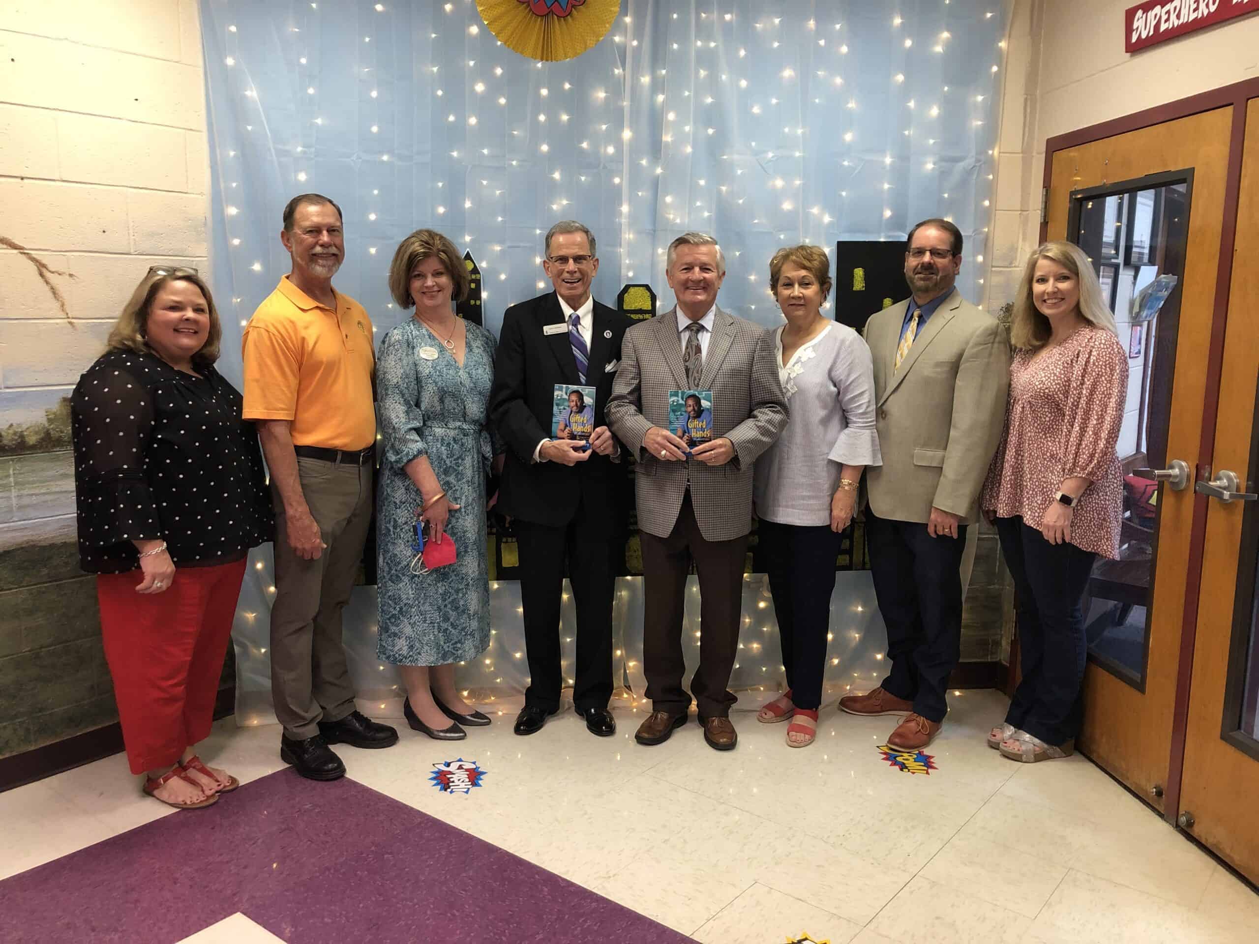 Members of OFTC, the Dublin and Cochran Rotary Clubs, Bleckley County Superintendent, and Bleckley County Elementary School Principal and Assistant Principal gathered for a photo prior to handing out the book Gifted Hands to 180 fifth grade students at Bleckley County Elementary School.