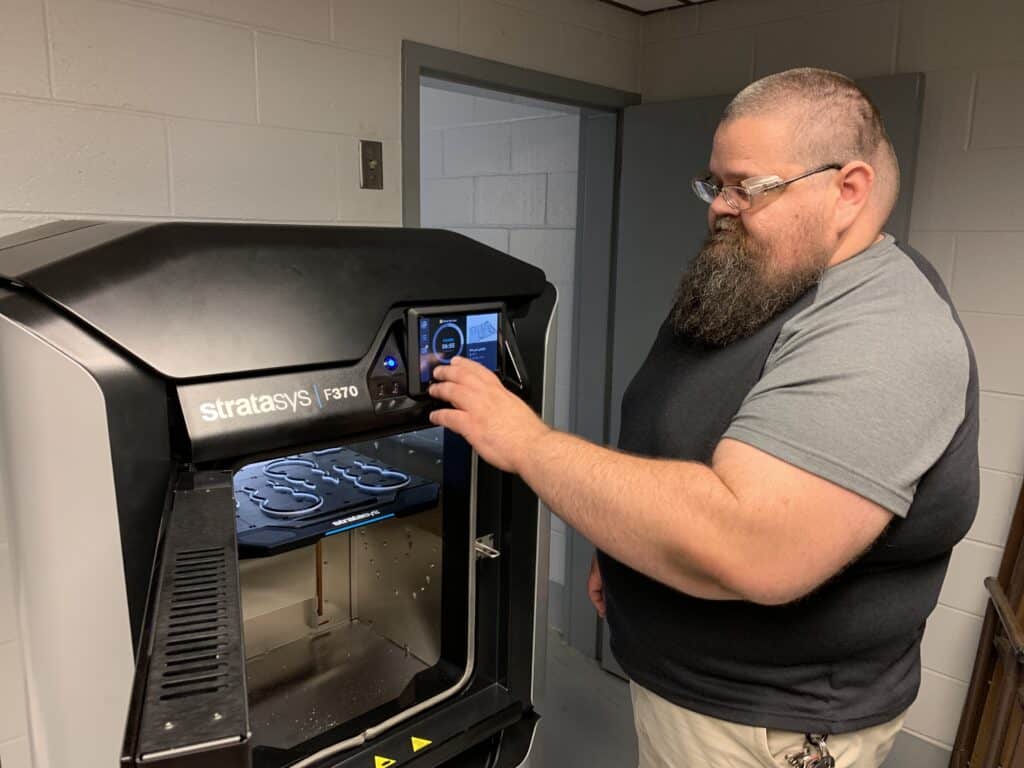 OFTC Machine Tool Student Jonathan Joiner works on the college's new 3D printer.