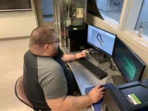 OFTC Machine Tool student Jonathan Joiner works on the Mastercam 3D printer software to draw and review the design before he prints.
