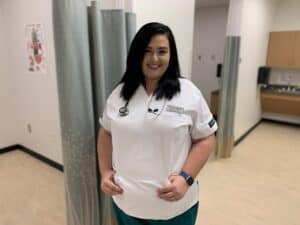 Sarah Chandler, OFTC Practical Nursing student, standing in nursing lab smiling