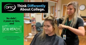OFTC student in cosmetology lab curling hair of another student