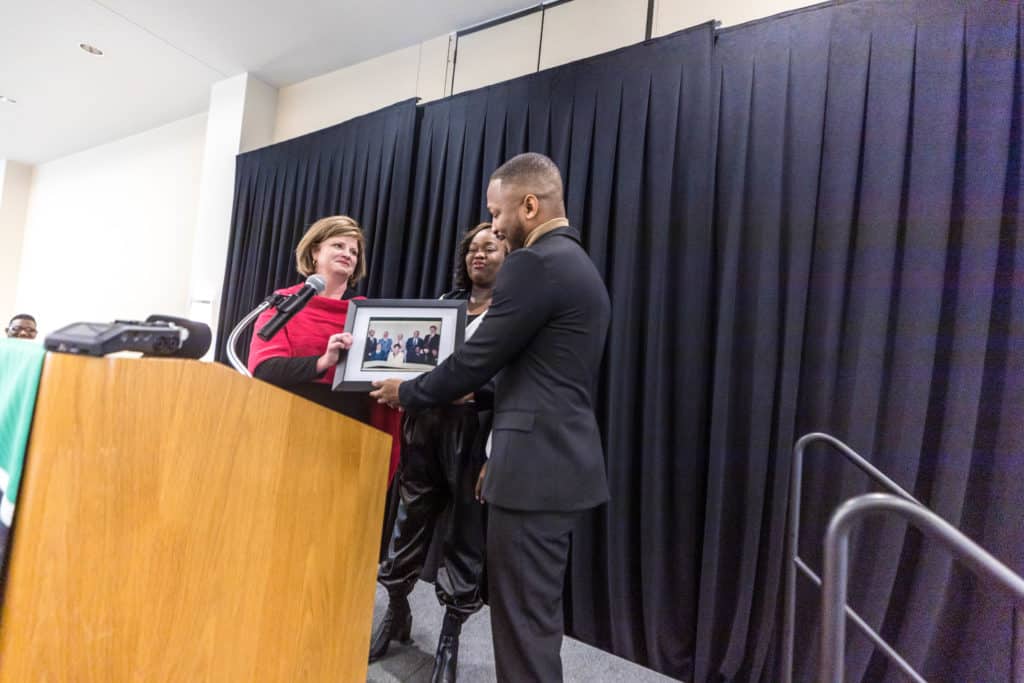 Norman Gyamfi receives photo of his grandmother who sat on OFTC's original board of directors in 1995.