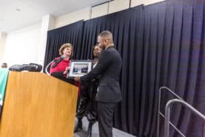 OFTC Black History Month speaker Norman Gyamfi receives photo of his grandmother who sat on OFTC's original board of directors in 1995.