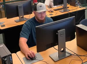 Cybersecurity student Parker Fountain working at his computer